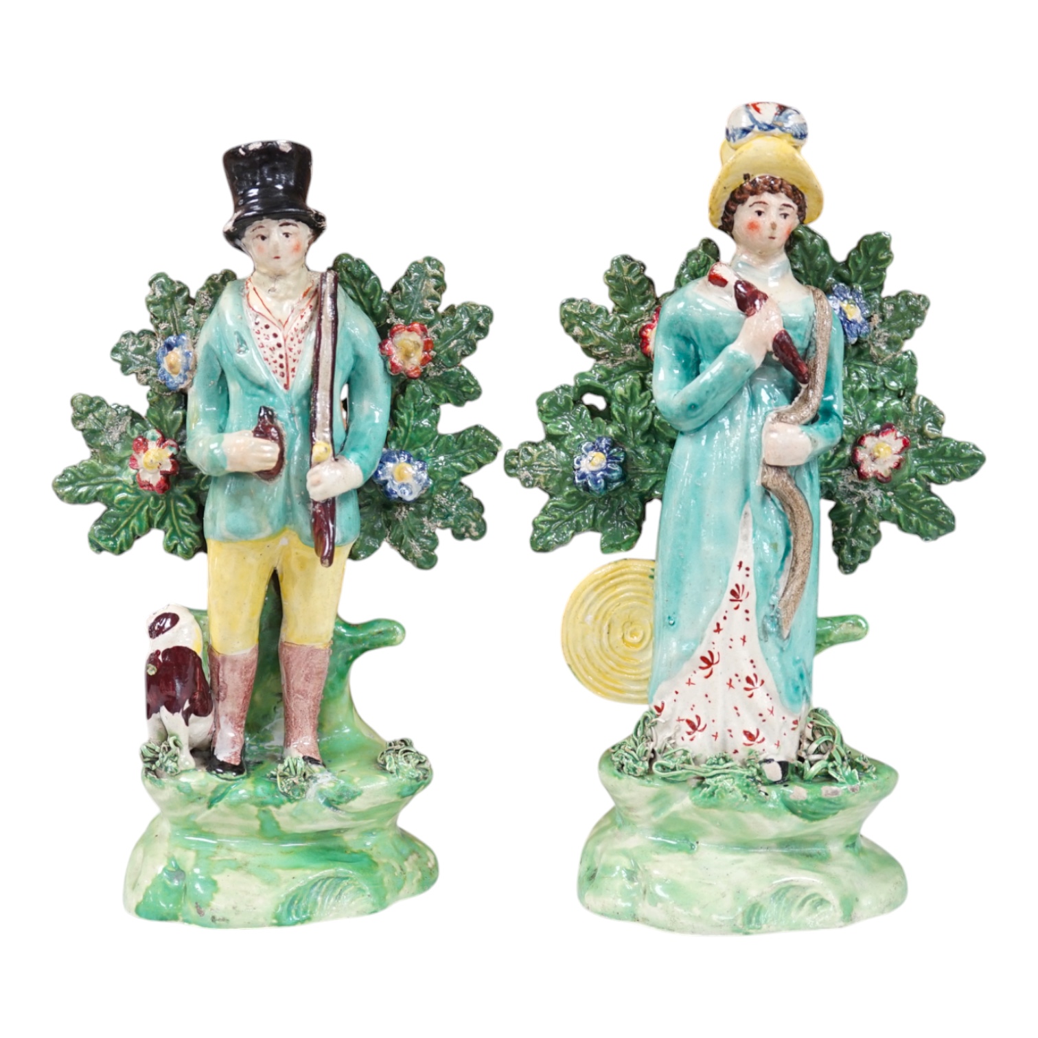 A pair of early 19th century pearlware figures of a huntsman and a female archer, 19.5cm high. Condition - some restoration otherwise in reasonable condition